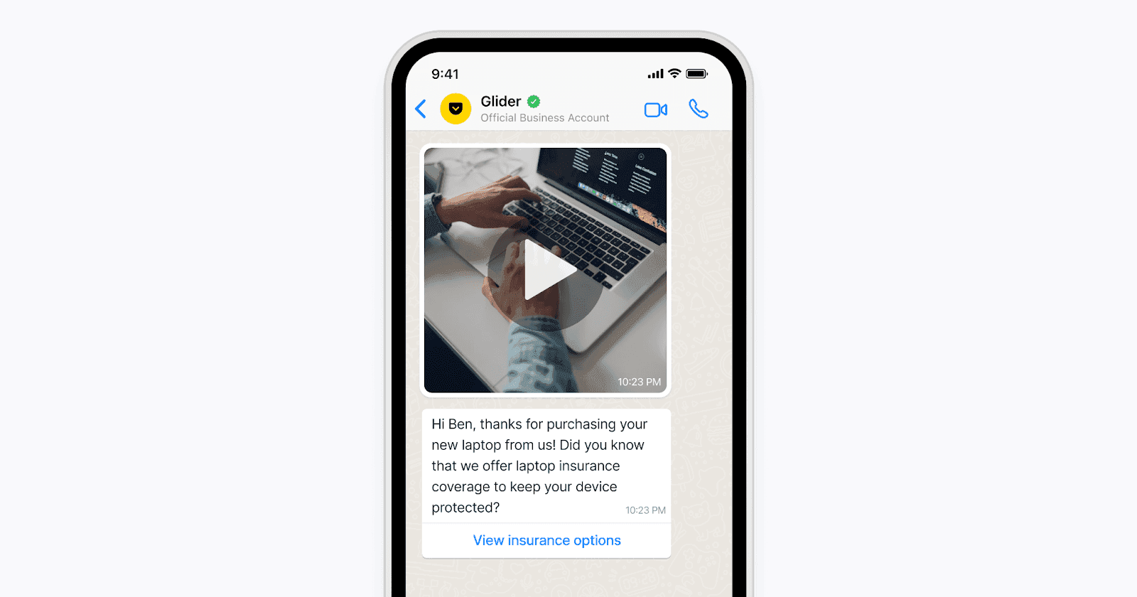 A smartphone screen displays a messaging app with a conversation featuring a business account communicating about laptop insurance.