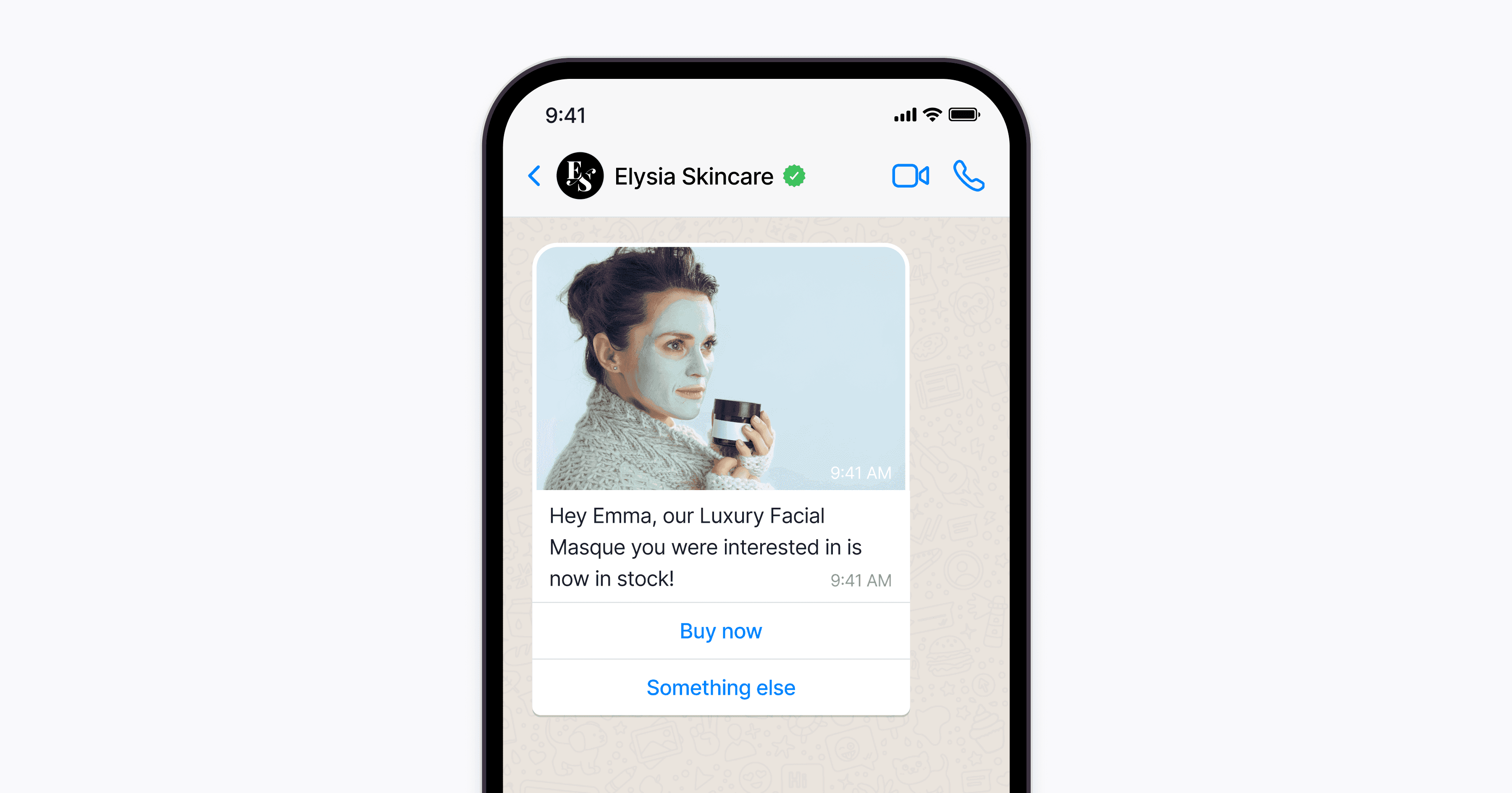 Smartphone displays a chat from Elysia Skincare, showing an image of a person holding a luxury facial masque jar with a message notifying its availability and options to "Buy now" or choose "Something else."